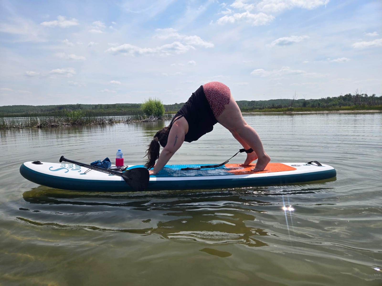 Kait practicing mindful movement on a paddleboard